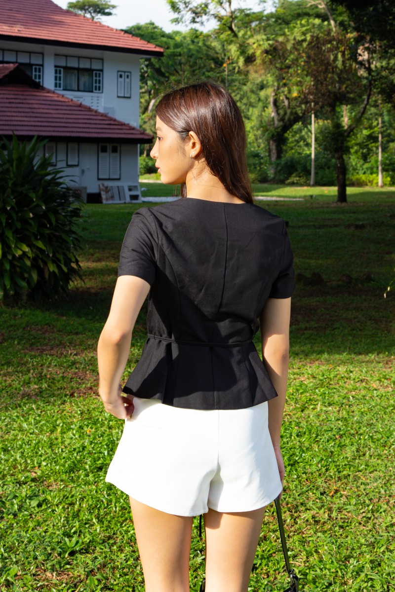 Jorelle Wrap Peplum Top in Black